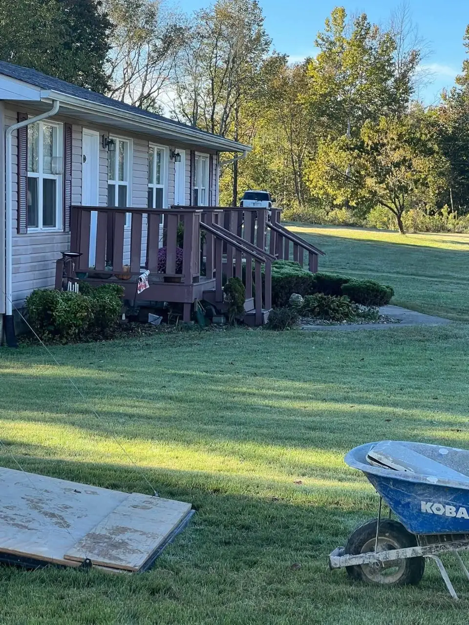 Before: Weathered stained wooden porch requiring demolition and structural upgrade