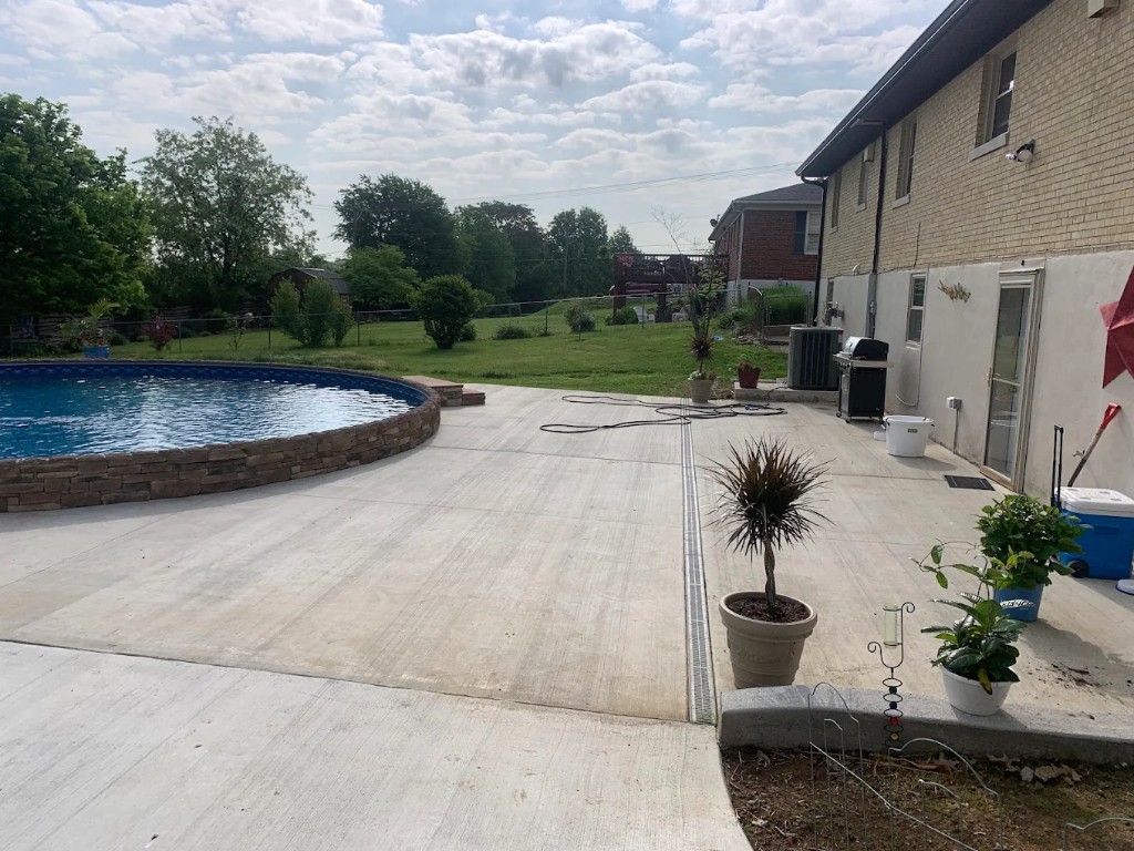 Concrete patio wrapped around an above-ground pool