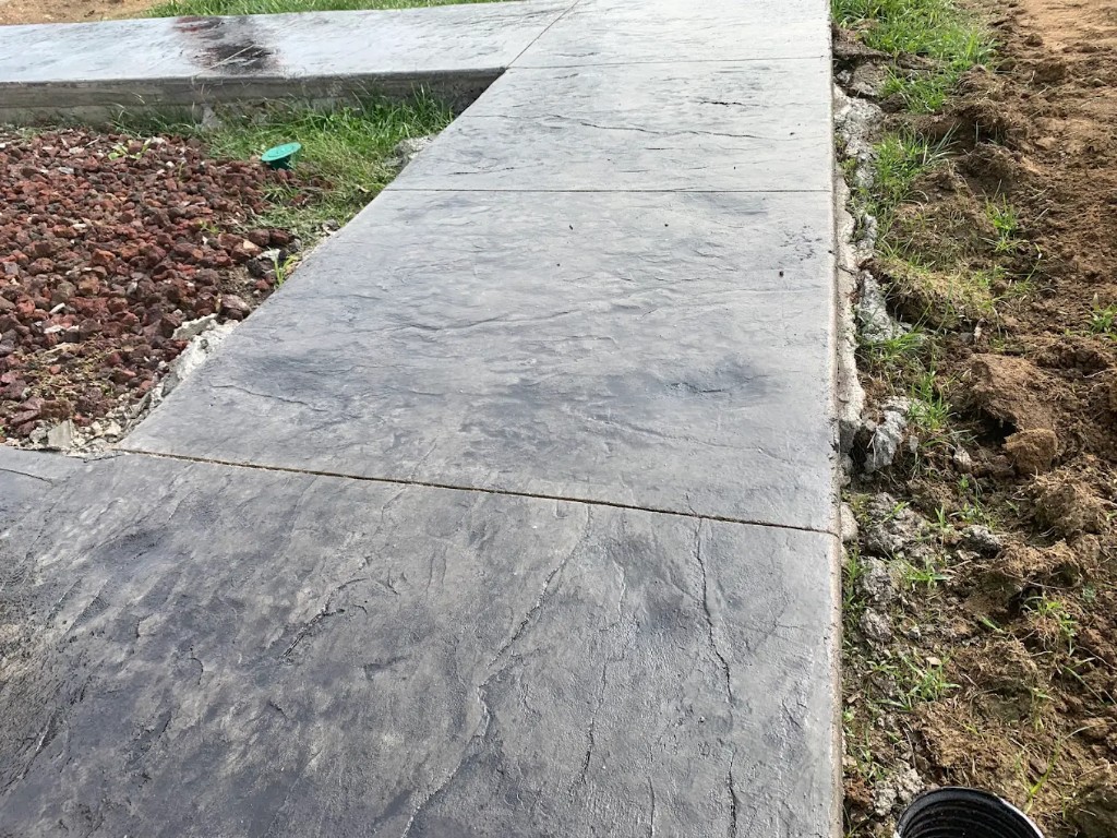 Close view of a slate-stamped concrete patio edge